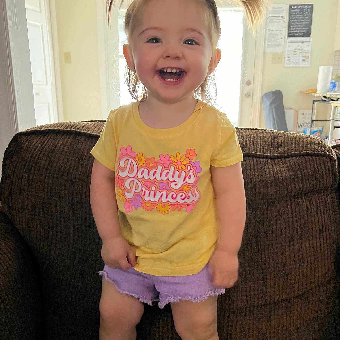 Addison is registered to the contest to win money with this photo: architecture, building, child, clothing, couch, cushion, face, female, furniture, girl, head, homedecor, indoors, livingroom, person, photography, portrait, room, shorts, t_shirt