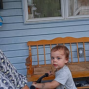 Allen joined the competition — help win amazing prizes! adult_partial, bench, bike, blue_siding, child, curious, daylight, handlebars, home, outdoor, patterned_shirt, person, porch, serious_expression, short_sleeve_shirt, toddler, toy, window, wooden_bench, yellow_shorts