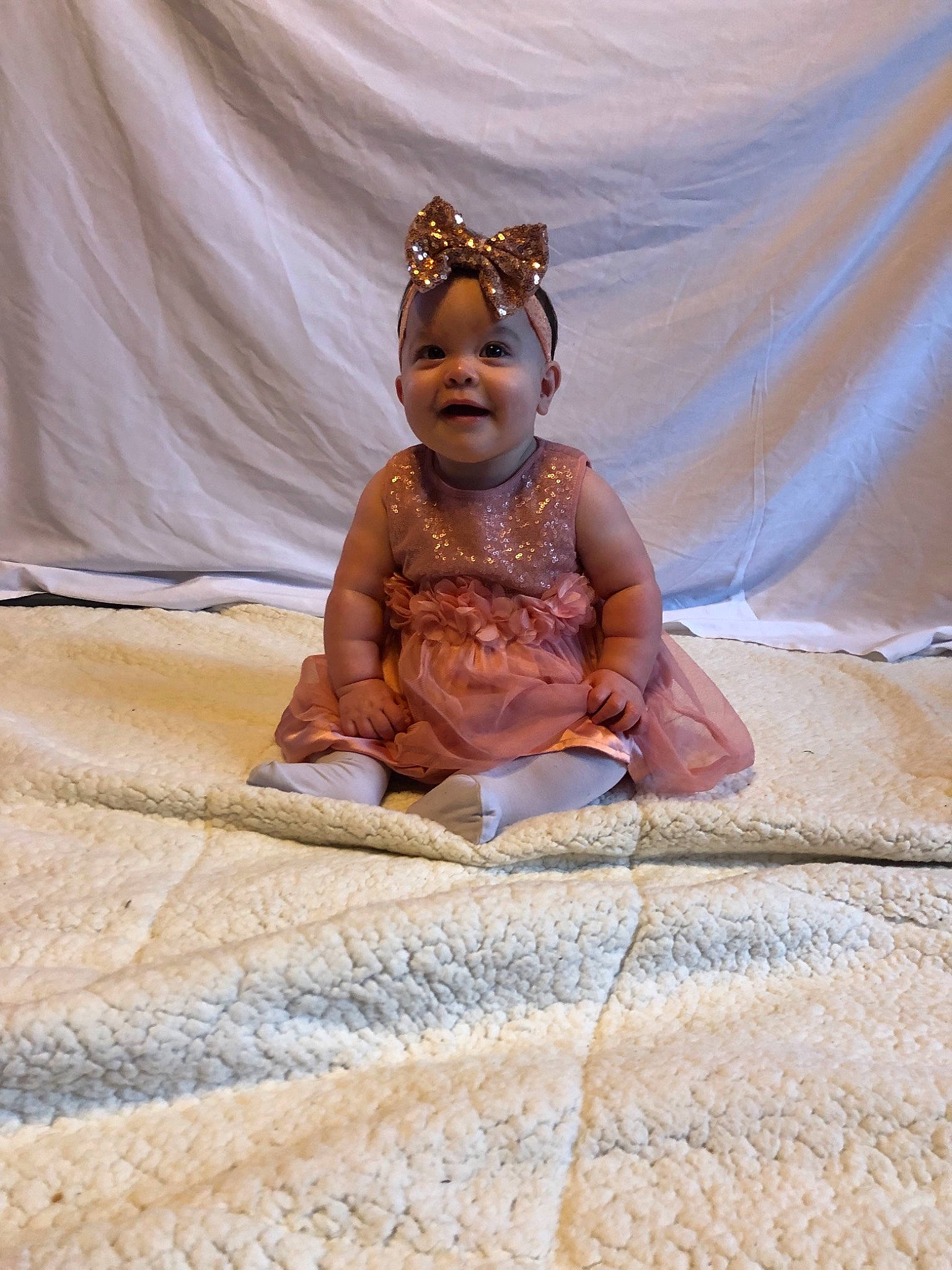 Alaska is registered to the contest to win money with this photo: baby, child, fawn, fictional_character, fun, person, sitting, smile, vacation