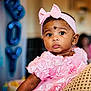 baby, child, girl, pink_dress, headband, bow, portrait, face, eyes, curious, celebration, balloons, party, closeup, infant, cute, adorable, soft_lighting, indoor, person