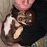 Tori is registered to the contest to win money with this photo: person, dog, pet, cuddle, indoor, blanket, pillow, close_up, face, smile, cute, relaxed, fur, animal, companion, resting, portrait, home, cute_pet, friendly