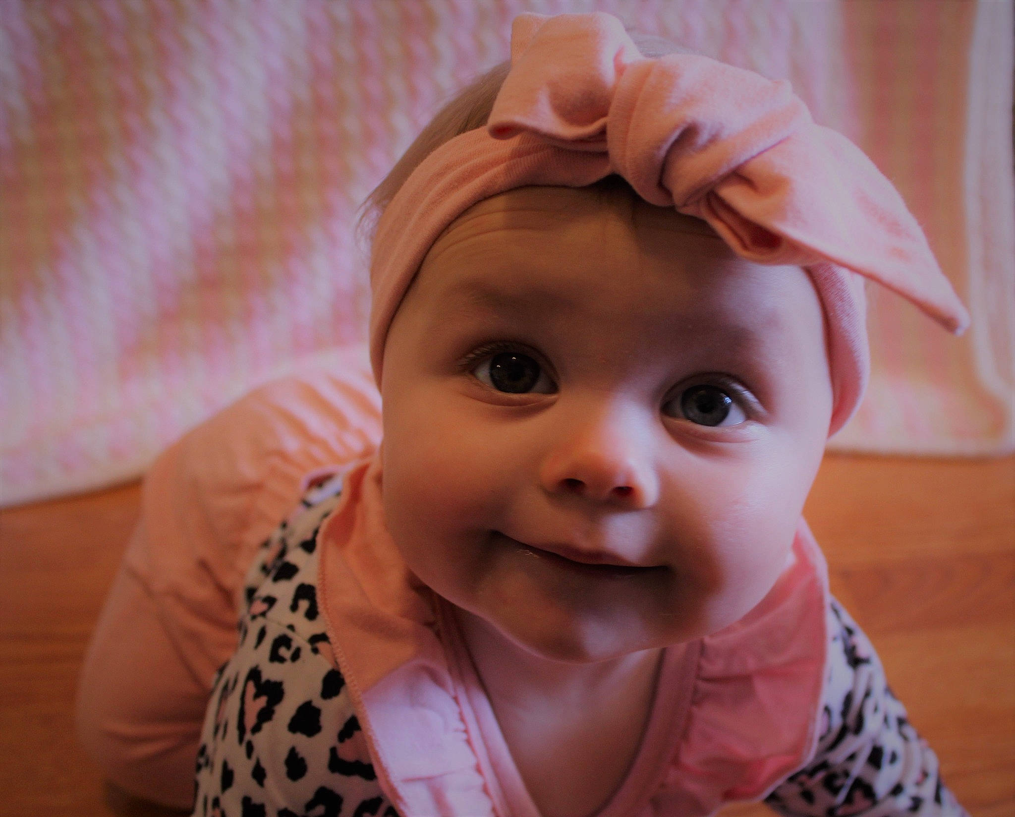 Hazel is registered to the contest to win money with this photo: baby, baby_toddler_clothing, cheek, child, ear, eyebrow, eyelash, fashion_accessory, gesture, happy, iris, lip, nose, person, pink, pleased, skin, sleeve, smile, thumb