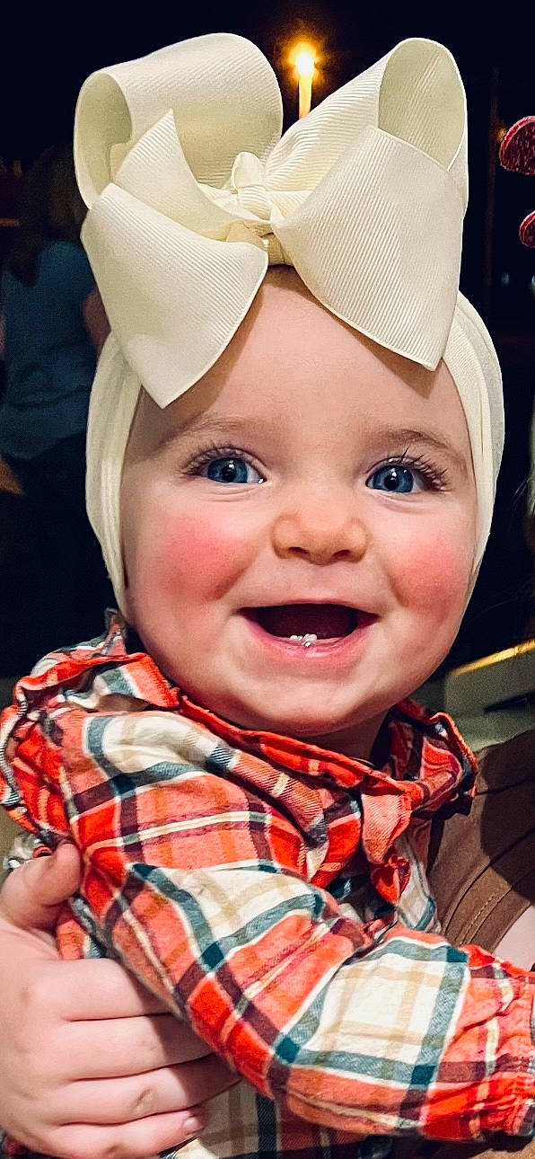 Maisyn joined the competition — help win amazing prizes! baby, baby_laughing, cap, child, event, eye, fun, happy, hat, headwear, joy, lip, mouth, nose, pattern, person, plaid, red, skin, smile
