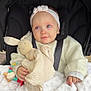 baby, blue_eyes, headband, stroller, toy, bunny, blanket, hand, clothing, warm, cute, child, infant, teething_ring, soft, comfort, portrait, indoor, seatbelt, expression