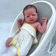 Jenson joined the competition — help win amazing prizes! baby, newborn, bath, bathtub, bubbles, towel, infant, skin, water, plastic, child, young, person, relaxing, cleaning, foam, cute, small, indoor, bathseat