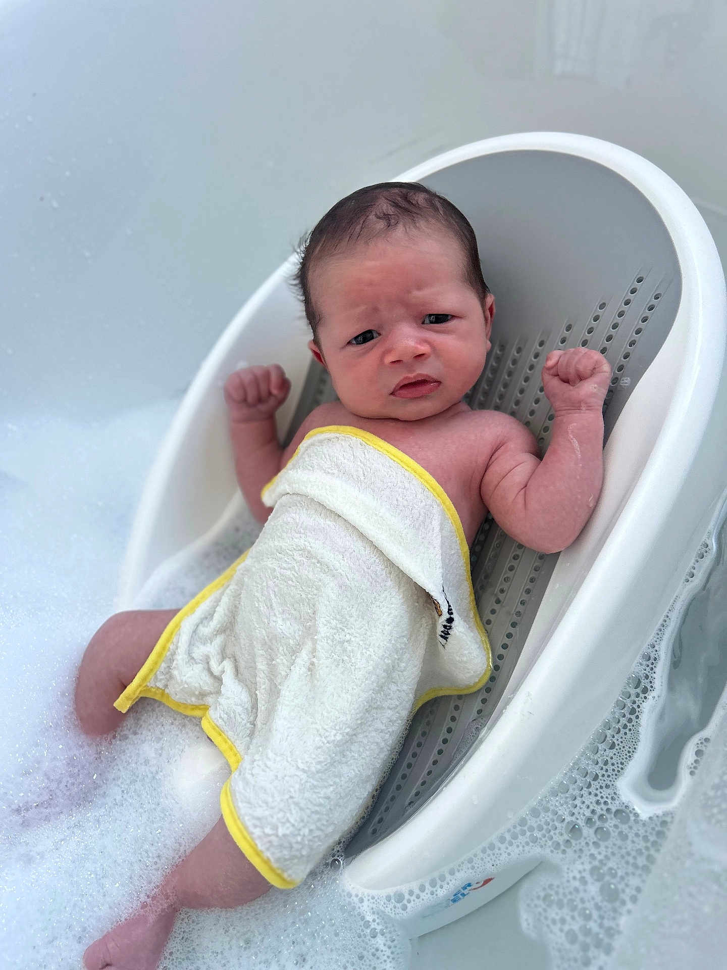 Jenson joined the competition — help win amazing prizes! baby, newborn, bath, bathtub, bubbles, towel, infant, skin, water, plastic, child, young, person, relaxing, cleaning, foam, cute, small, indoor, bathseat