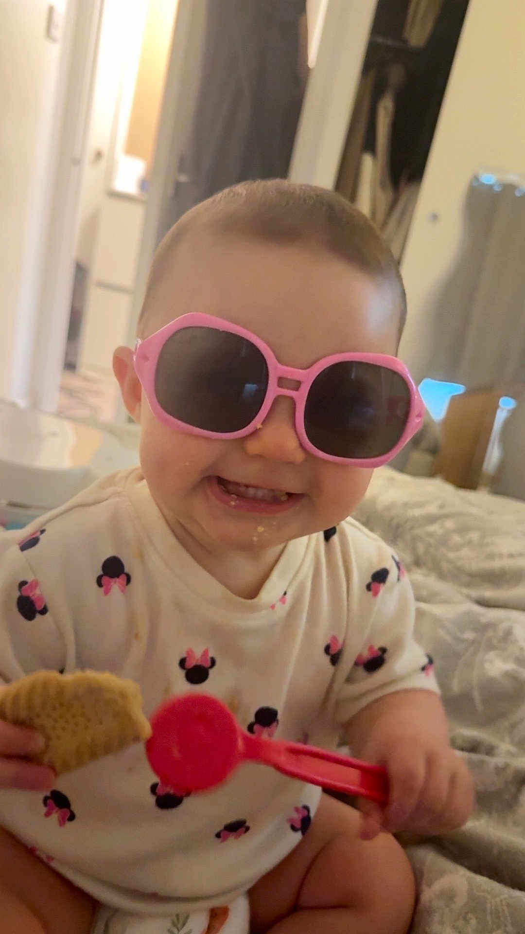 Alora-Mae joined the competition — help win amazing prizes! baby, child, sunglasses, pink, smiling, toy, biscuit, clothing, indoor, bed, cute, happy, person, face, sitting, diaper, infant, playful, home, toddler