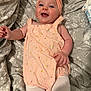 Alora-Mae is registered to the contest to win money with this photo: baby, infant, smiling, headband, romper, patterned_blanket, happy, lying_down, cute, child, soft_lighting, indoor, person, baby_clothes, white_tights, skin, face, hand, legs, cheerful