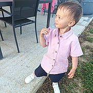 Timaé joined the competition — help win amazing prizes! toddler, child, boy, pink_shirt, shorts, white_shoes, outdoor, patio, table, chairs, grass, concrete, curious_expression, daylight, side_view, holding_object, messy_shirt, casual, person, small_child