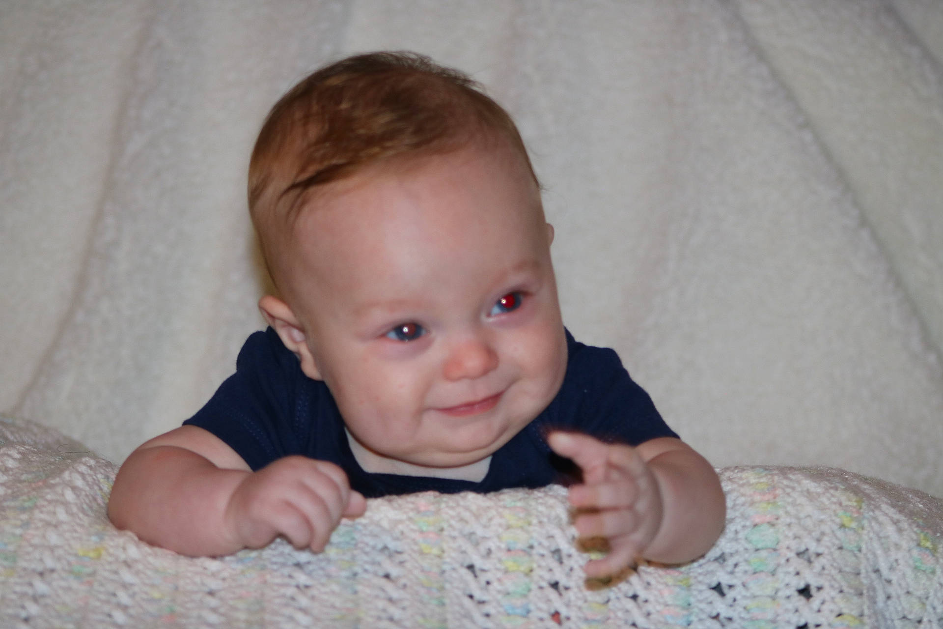 T.j is registered to the contest to win money with this photo: baby, baby_toddler_clothing, cheek, chin, comfort, eyebrow, flash_photography, flooring, gesture, happy, iris, linens, lip, nose, person, skin, sleeve, smile, thumb, toddler