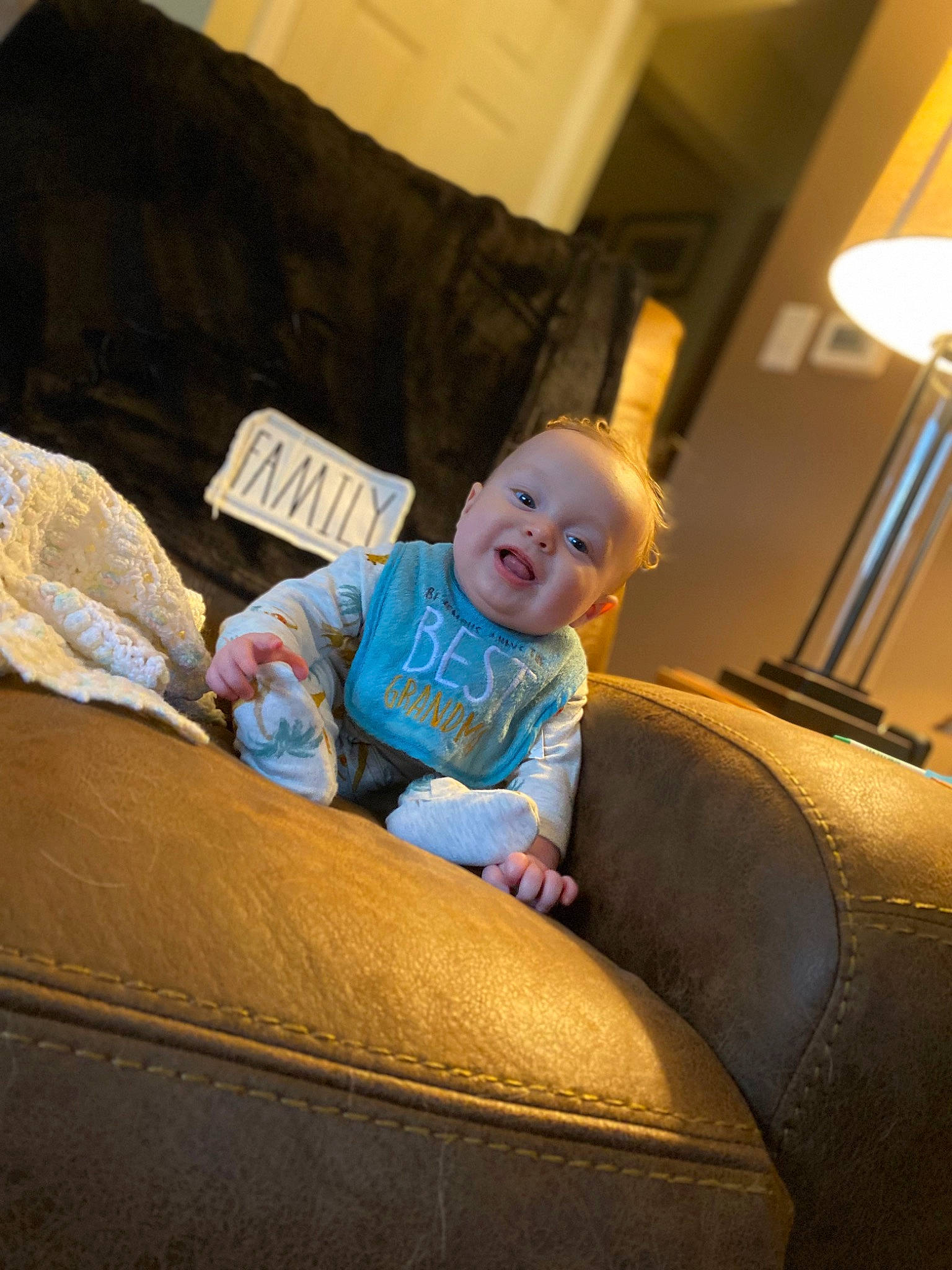 T.j is registered to the contest to win money with this photo: auto_part, automotive_design, baby, baby_toddler_clothing, child, comfort, couch, flooring, fun, human_leg, lamp, leisure, living_room, luxury_vehicle, person, room, sitting, smile, tints_and_shades, toddler