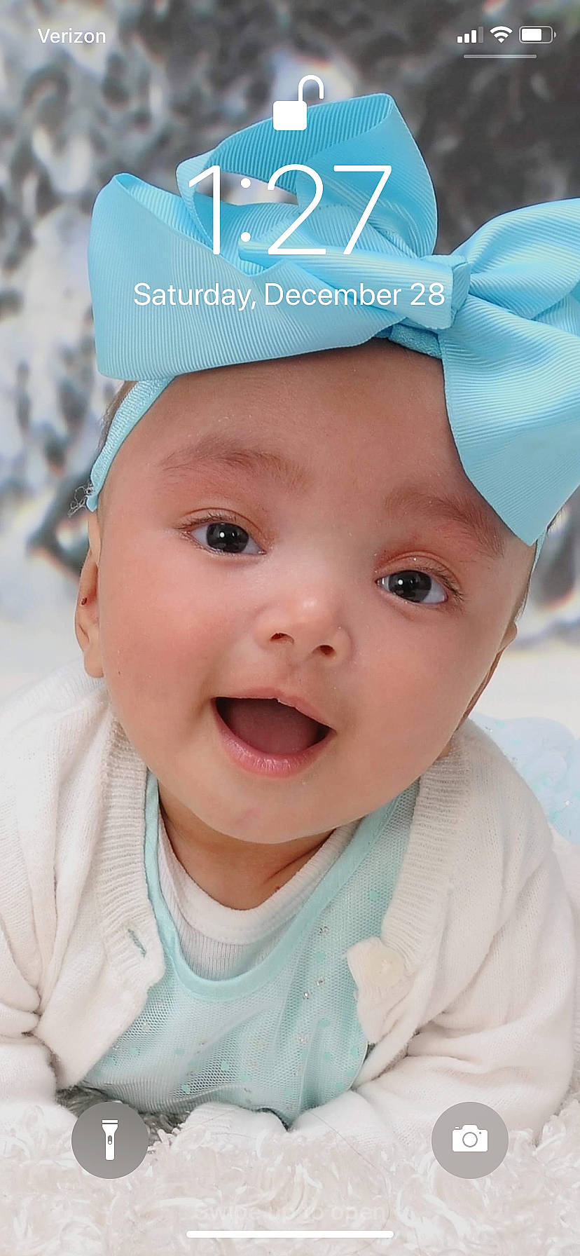 Sophia is registered to the contest to win money with this photo: baby, baby_making_funny_faces, cheek, child, chin, face, facial_expression, forehead, hair_accessory, head, headgear, headwear, lip, nose, person, skin, smile, toddler, turquoise