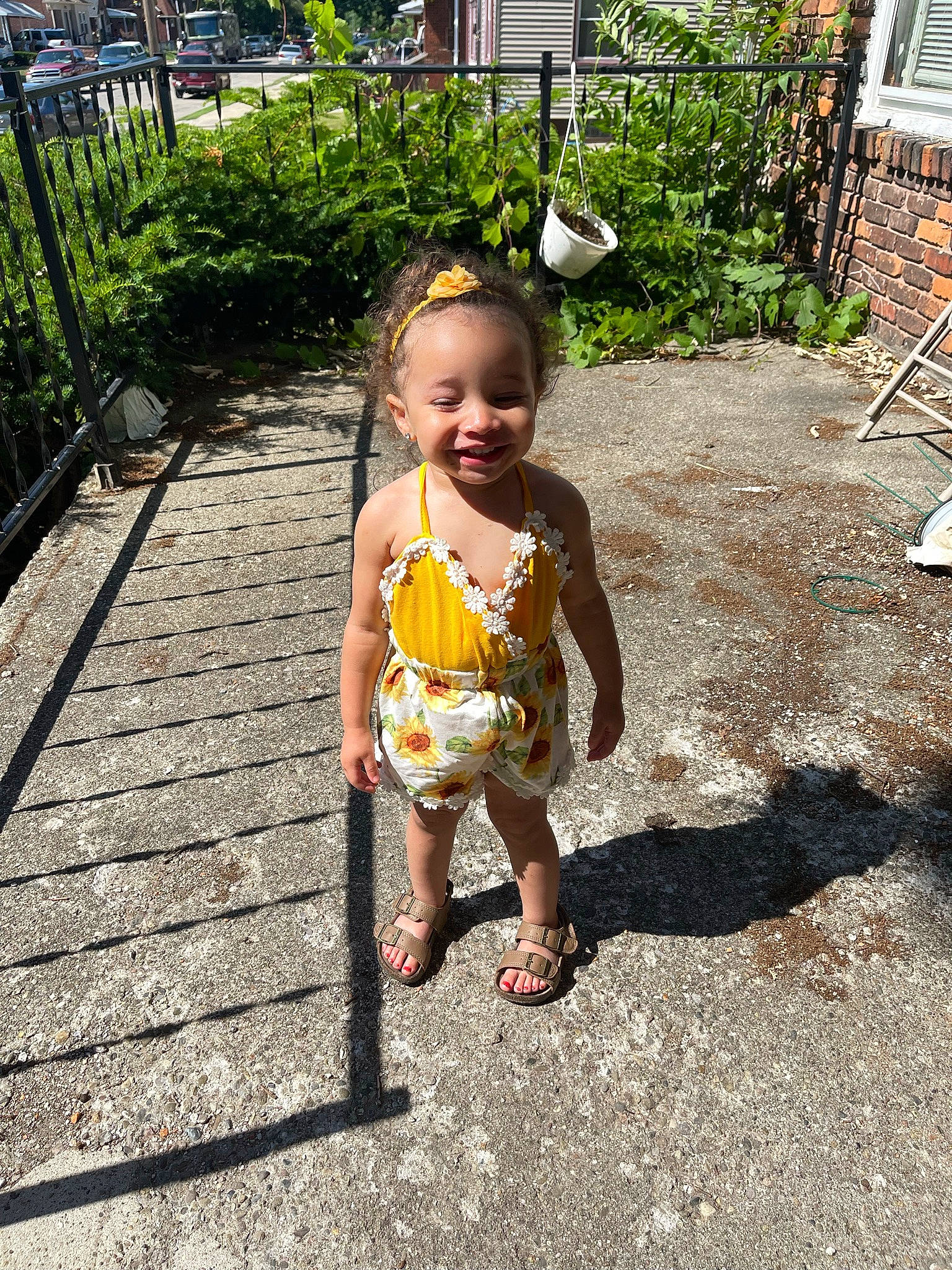 Danielle is registered to the contest to win money with this photo: asphalt, baby, child, dress, eye, fence, fun, grass, grass_family, happy, joy, landscape, leisure, people_in_nature, person, plant, recreation, road_surface, sidewalk, smile