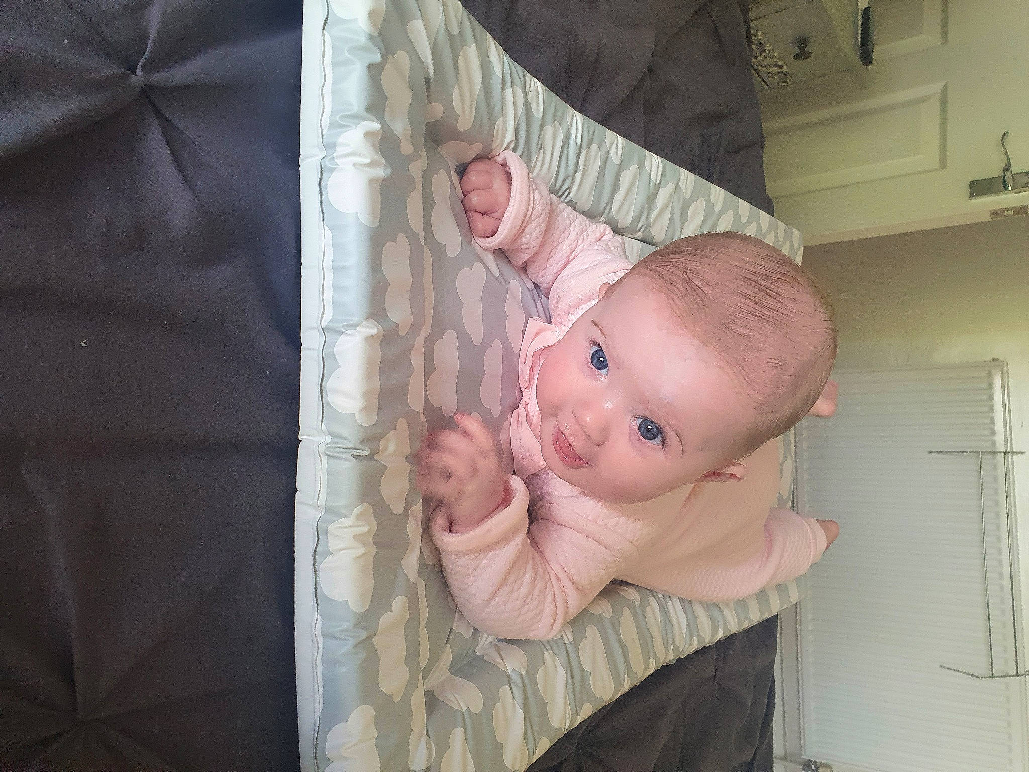 Darcy is registered to the contest to win money with this photo: baby, baby_products, baby_safety, bed, cheek, child, furniture, infant_bed, linens, person, product, room, skin, textile, toddler