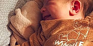 Naël participe au concours pour gagner de l'argent avec cette photo : baby, infant, sleeping, smiling, blanket, clothing, winnie_the_pooh, sweater, couch, soft_lighting, indoor, cozy, resting, child, person, head, ear, fabric, comfort, cute