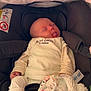 Charlie participe au concours pour gagner de l'argent avec cette photo : baby, sleeping, tongue_out, car_seat, blanket, pacifier, clothing, infant, soft_toy, child, cute, resting, newborn, cozy, indoors, fabric, comfort, peaceful, wrapped, person