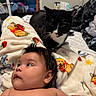 Araceli is registered to the contest to win money with this photo: animal, baby, bed, blanket, cat, child, face, fur, fur_pattern, furniture, home, indoor, laying_down, looking_away, person, pet, portrait, resting, soft, winnie_the_pooh