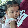 Araceli is registered to the contest to win money with this photo: adult, arm, baby, car_interior, car_seat, casual, child, closeup, cuddling, face, hair_clips, head, holding, infant, lace, person, pink_clothing, portrait, sunlight, window