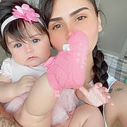 Emily joined the competition — help win amazing prizes! baby, child, adult, portrait, smiling, pink, headband, flower, plush_toy, stuffed_animal, holding, cuddle, indoors, bedroom, door, tattoo, braid, closeup, family, photography