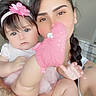baby, child, adult, portrait, smiling, pink, headband, flower, plush_toy, stuffed_animal, holding, cuddle, indoors, bedroom, door, tattoo, braid, closeup, family, photography