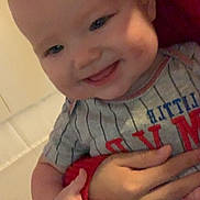 Waylon joined the competition — help win amazing prizes! baby, child, smile, hand, striped_shirt, indoor, person, face, holding, cheeks, joyful, cute, infant, closeup, human, skin, expression, young, portrait, cuddle