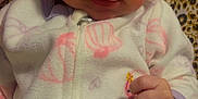 Wania joined the competition — help win amazing prizes! baby, infant, onesie, hand, patterned_blanket, owl_patch, pink, white_clothing, closeup, face, expression, cute, indoor, person, newborn, child, soft_fabric, sleepwear, holding, skin