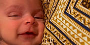 Wania is registered to the contest to win money with this photo: baby, child, closeup, comfort, cozy, cute, face, hand, indoor, infant, newborn, pajamas, patterned_pillow, person, relaxing, resting, skin, sleepy, smile, young