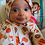 baby, infant, headband, onesie, pumpkin, donut, patterned_clothing, monkey, palm_tree, colorful, wide_eyes, cute, portrait, child, indoor, smiling, seated, playful, background, close_up