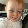 Oliver is registered to the contest to win money with this photo: toddler, child, smile, blue_eyes, red_hair, white_shirt, indoor, kitchen, microwave, refrigerator, person, face, cute, portrait, young_child, happy, close_up, home, casual, light