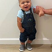 Mateo joined the competition — help win amazing prizes! toddler, child, smiling, denim_overalls, gray_sneakers, standing, hand_support, indoor, wooden_floor, white_wall, cute, happy, baby, person, footwear, casual_clothing, young_child, portrait, human, one_person