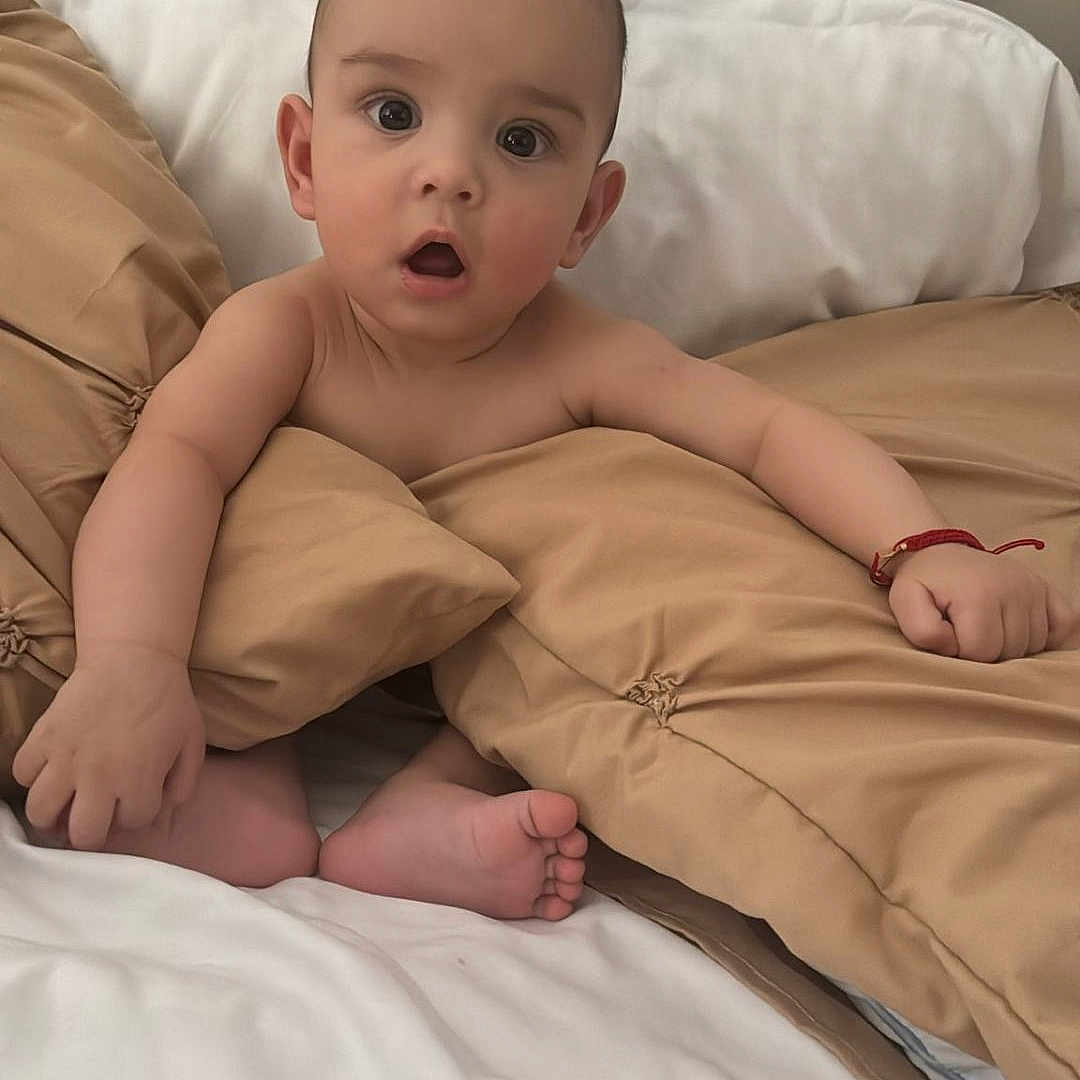 Sian joined the competition — help win amazing prizes! baby, bed, blanket, bracelet, child, comfort, cute, expression, foot, hand, headboard, indoors, infant, pillow, resting, skin, sleepwear, soft, surprised, young