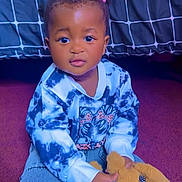 Lauryn joined the competition — help win amazing prizes! toddler, child, indoor, carpet, sitting, sweatshirt, blue, tie_dye, jeans, toy, teddy_bear, plush, hair_ties, curtain, grid_pattern, person, cute, young_child, portrait, hands