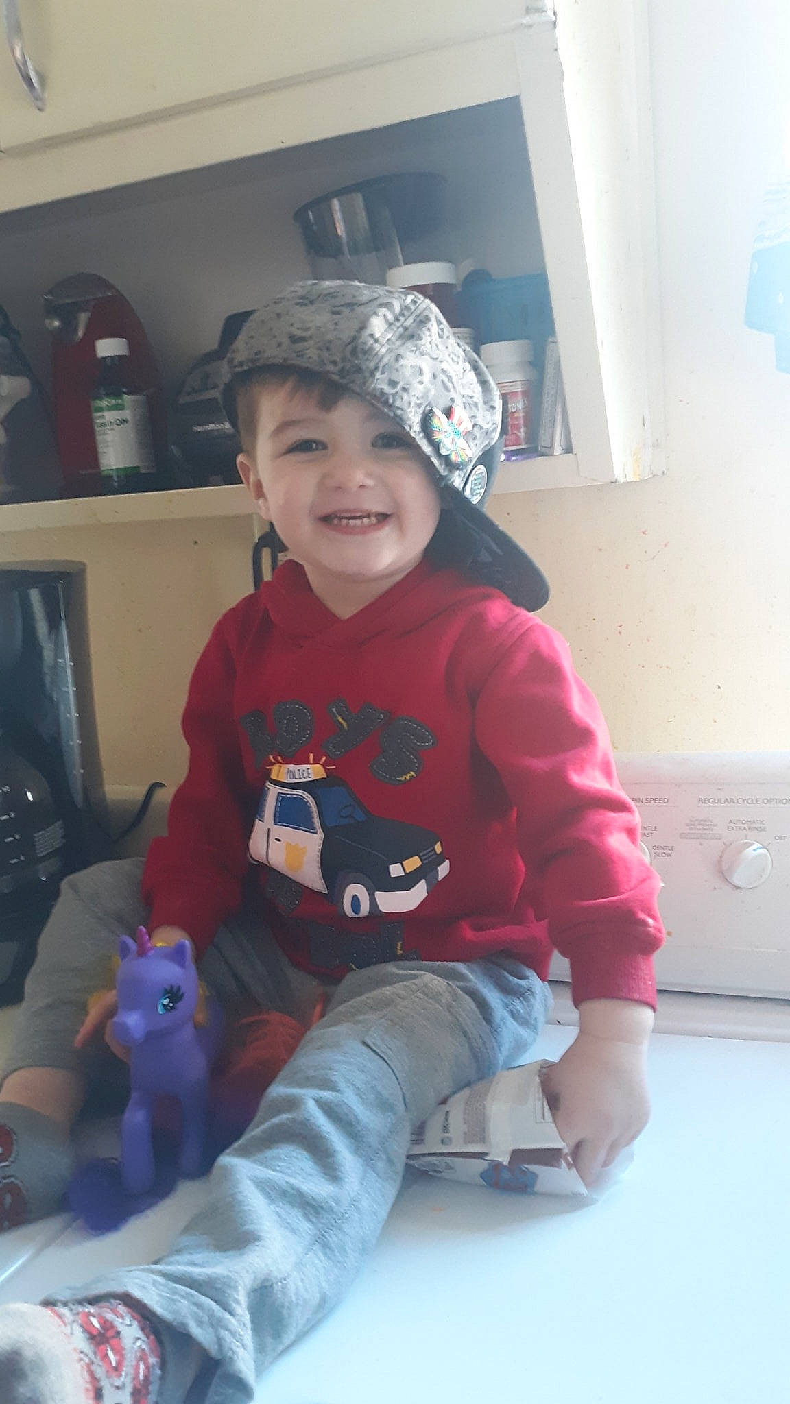 Julien is registered to the contest to win money with this photo: baby, cheek, child, headgear, joy, person, pink, sitting, skin, smile, t_shirt, toddler