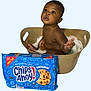 Legend is registered to the contest to win money with this photo: baby, child, milk, cookie, chips_ahoy, plastic_tub, snack, food, milk_bath, cute, expression, indoor, brown_skin, sitting, curious, holding, package, blue_package, chocolate_chip_cookie, playful