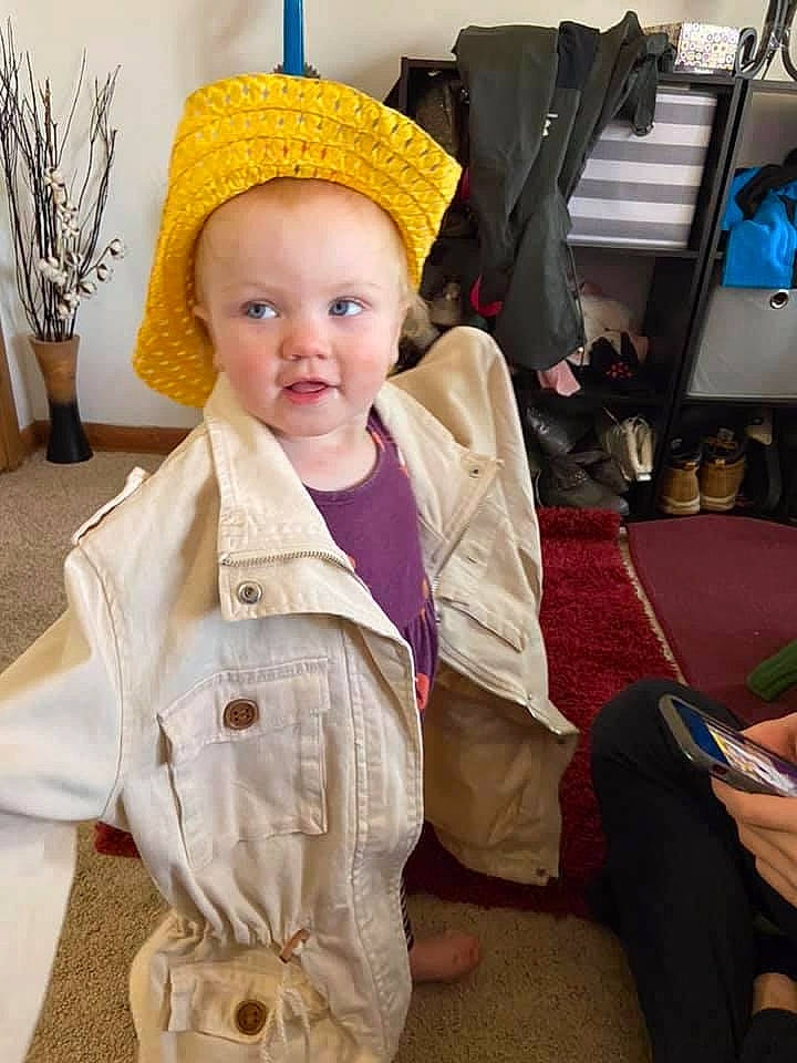 Calista is registered to the contest to win money with this photo: baby, baby_products, baby_toddler_clothing, bag, bonnet, costume, costume_accessory, costume_hat, flowerpot, foot, gadget, hand, headgear, houseplant, lap, mobile_phone, nail, overall, person, portable_communications_device