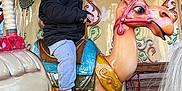 Mylann a rejoint le concours — aidez-le/la à gagner de superbes lots ! amusement_park, camel, carousel, child, clothing, colorful, decorative, entertainment, fun, happy, jacket, joy, outdoor, person, playful, ride, seat, smile, sneakers, vintage