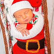 Zayne is registered to the contest to win money with this photo: baby, infant, sleeping, knitted_clothing, santa_hat, red_clothing, white_clothing, basket, blanket, holiday_theme, christmas, festive, pattern, fabric, plush, cute, peaceful, child, portrait, wrapped