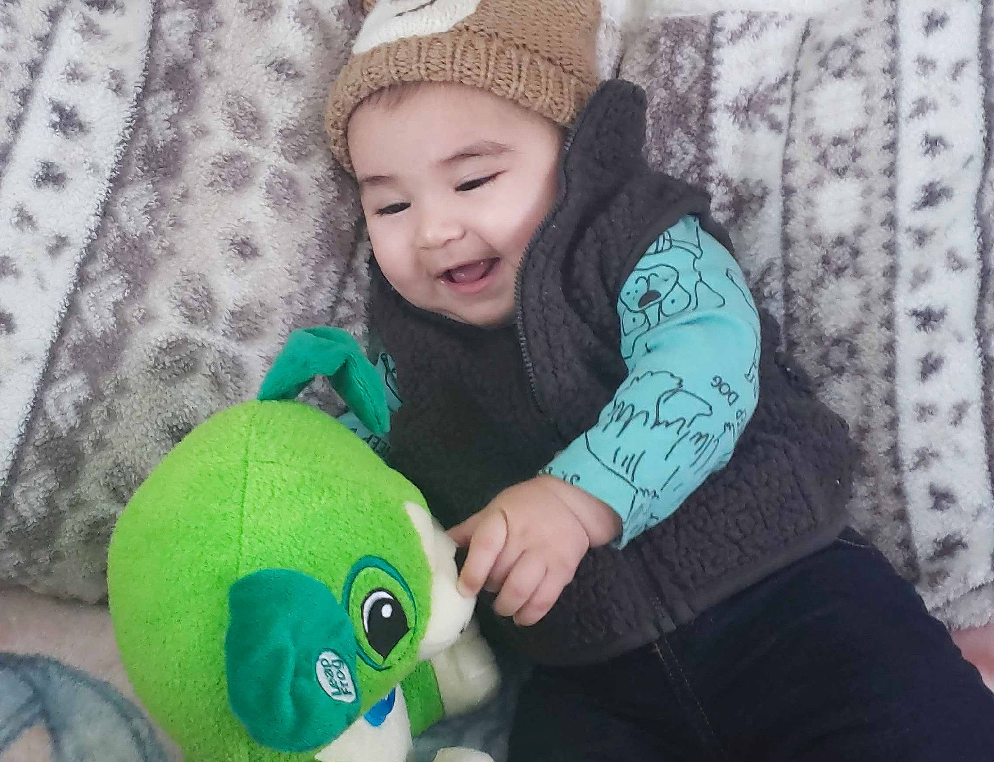 Landyn joined the competition — help win amazing prizes! beanie, cap, child, cool, green, headgear, infant, knit_cap, material, nose, person, play, plush, product, skin, smile, stuffed_toy, textile, toddler, toy