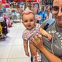 Maëly participe au concours pour gagner de l'argent avec cette photo : baby, unicorn_headband, woman, glasses, store, shopping, colorful, clothing, smile, holding, person, retail, indoor, tiles, backpack, shelf, product, casual, headwear, child
