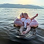 Maëly participe au concours pour gagner de l'argent avec cette photo : baby, water, lake, inflatable_ring, life_vest, child, floating, outdoor, nature, mountains, sunset, calm, serene, summer, swimming, recreation, vacation, water_sport, relaxation, peaceful