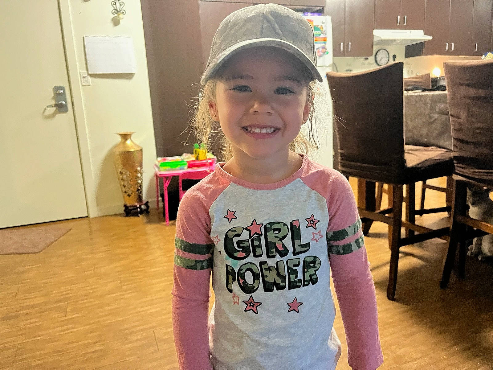 Maia joined the competition — help win amazing prizes! baby_toddler_clothing, baseball_cap, cap, chair, child, door, event, flooring, fun, happy, headwear, joy, leisure, magenta, person, room, sleeve, smile, standing, t_shirt