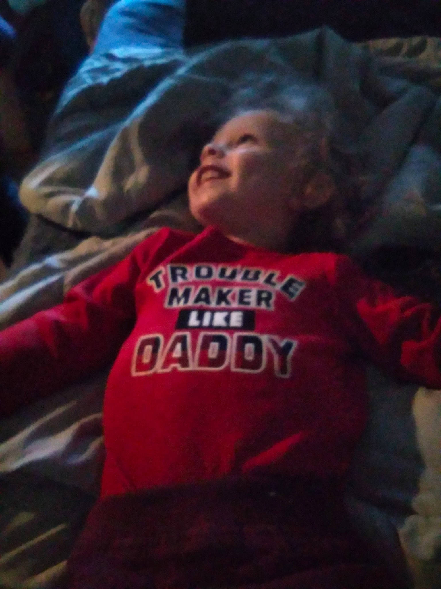 Jackson is registered to the contest to win money with this photo: baby, carmine, child, comfort, darkness, electric_blue, flesh, fun, happy, hood, hoodie, linens, magenta, mouth, person, room, sitting, sleeve, smile, t_shirt