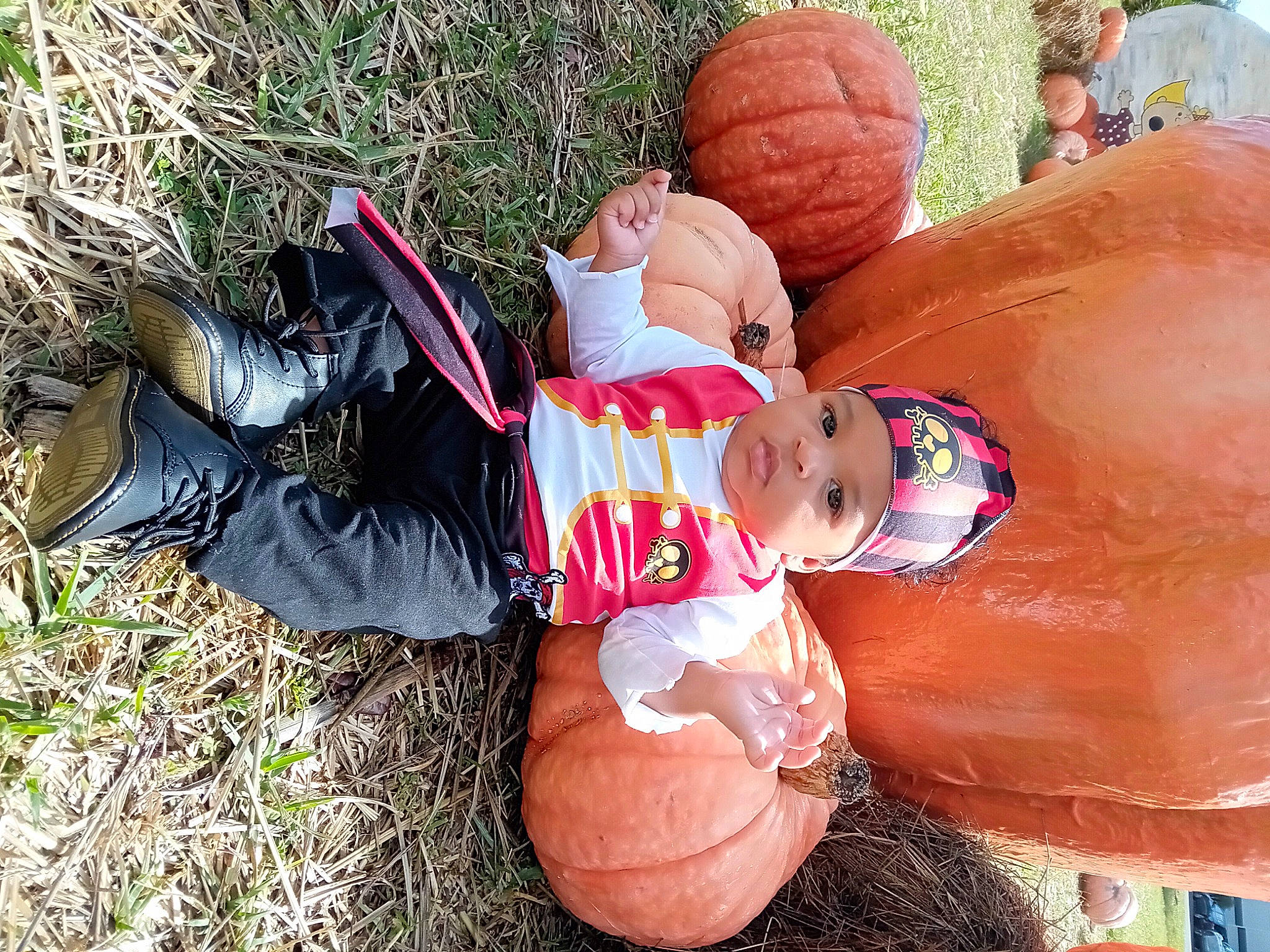 Johnny joined the competition — help win amazing prizes! art, baby_toddler_clothing, calabaza, child, cucurbita, fun, goggles, gourd, grass, hat, headwear, lawn_ornament, leisure, person, plant, pumpkin, shorts, squash, sunglasses, toddler