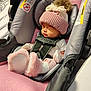 Reina joined the competition — help win amazing prizes! baby, car_seat, pink, hat, sleeping, infant, strap, cozy, pom_pom, clothing, plush, cute, indoors, newborn, child, soft, resting, warm, seat, face