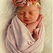 Reina joined the competition — help win amazing prizes! newborn, baby, sleeping, wrapped, blanket, pink, flower_headband, floral, soft_texture, peaceful, closeup, portrait, infant, cute, resting, hands, face, skin, cozy, white_background
