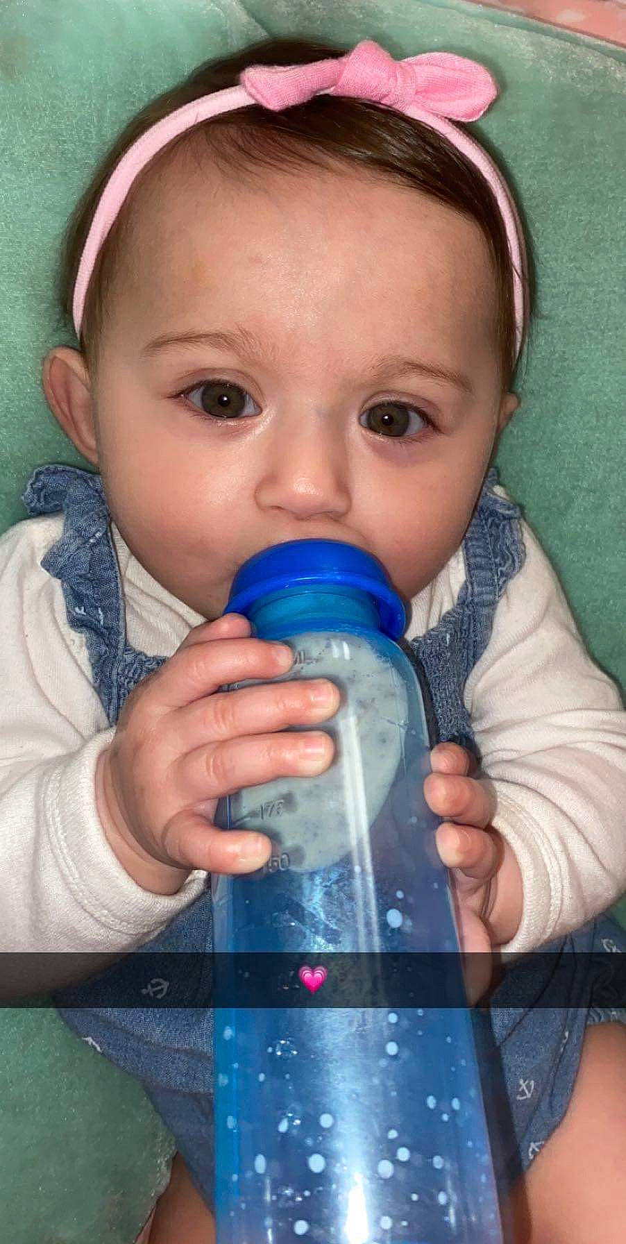 Ava Nichole joined the competition — help win amazing prizes! baby_bottle, bottle, cheek, drink, drinking, drinkware, ear, eyelash, finger, fluid, hand, liquid, nose, organ, person, plastic_bottle, product, skin, toddler, water
