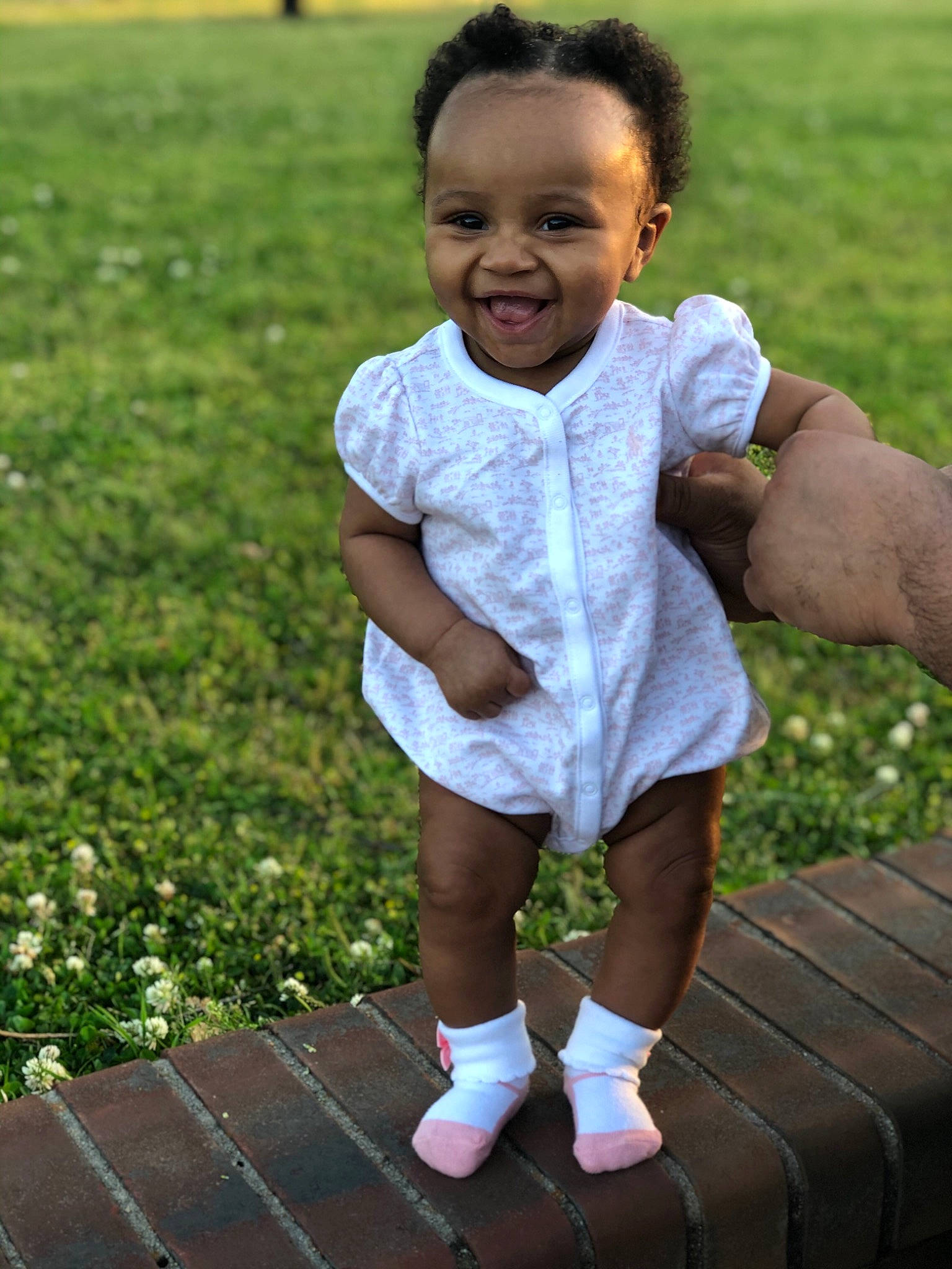 Jelena is registered to the contest to win money with this photo: baby, baby_toddler_clothing, child, fun, grass, happy, joy, person, play, shoe, sitting, skin, smile, standing, toddler