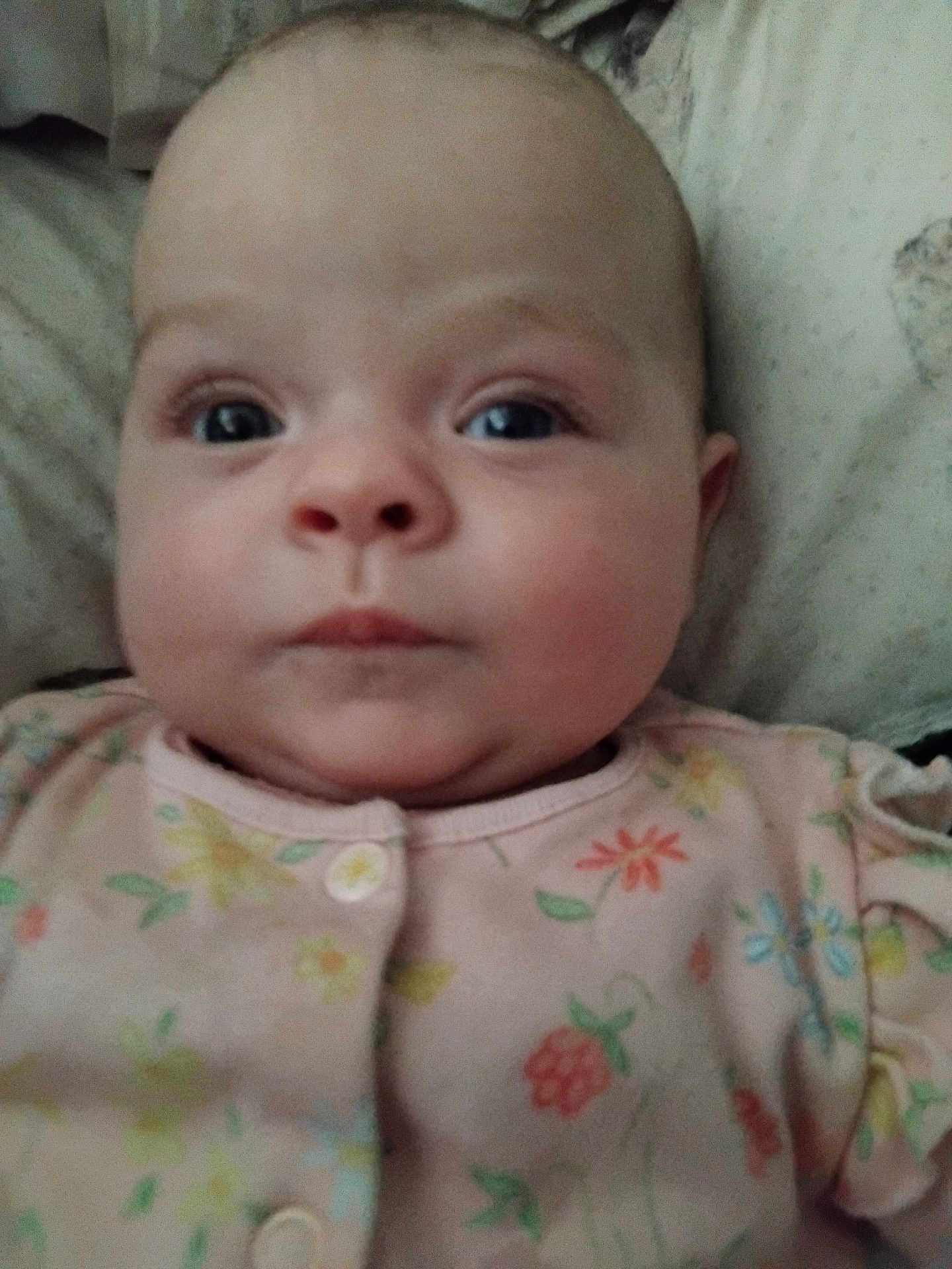 Dilillah joined the competition — help win amazing prizes! baby, infant, face, close_up, person, child, onesie, clothing, floral_pattern, cute, skin, head, eyes, nose, mouth, cheeks, indoor, soft, lying_down, portrait