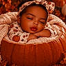 Kailani is registered to the contest to win money with this photo: baby, infant, sleeping, portrait, pumpkin, autumn, fall, blanket, knitted_blanket, headband, bow, floral_clothing, onesie, cozy, warm_lighting, orange, leaves, seasonal, indoor, photography