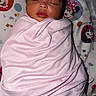 baby, newborn, sleeping, swaddled, pink_blanket, crib, infant, portrait, face, closed_eyes, peaceful, indoors, bedding, cartoon_blanket, minnie_mouse, colorful, nursery, lying_down, cute, child